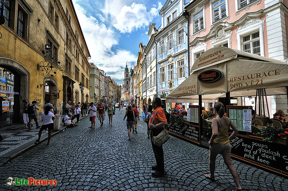 Tourists in Prague on the street to the castle