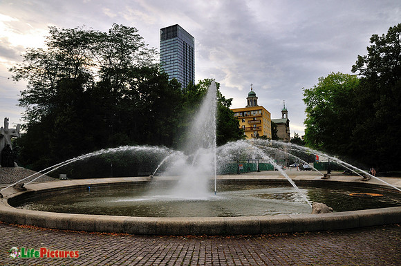 Fountain and dark sky over Warsaw